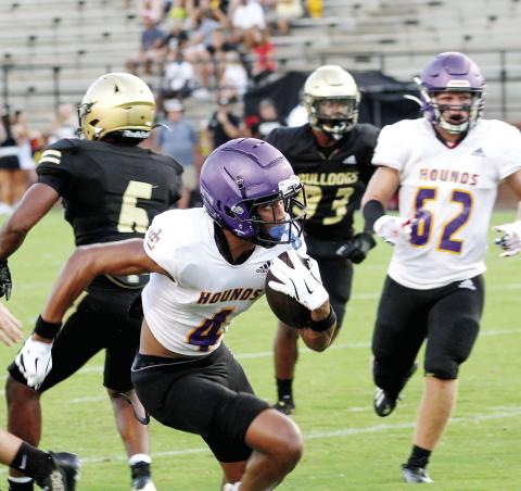 Greyhounds receiver Jaivon Solomon races away from Mary Persons defenders for a touchdown during Friday’s scrimmage against the Bulldogs. BRAD HARRISON/Staff