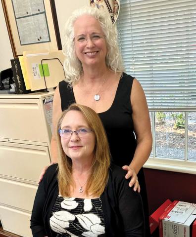 Cindy (standing) and Heather ready to work. CONTRIBUTED