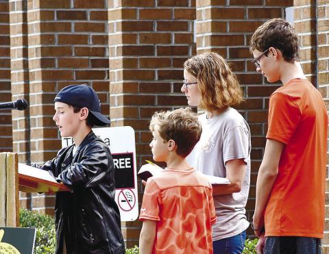 The Abney family reading from the Bible during last year’s annual Bible reading marathon. CONTRIBUTED