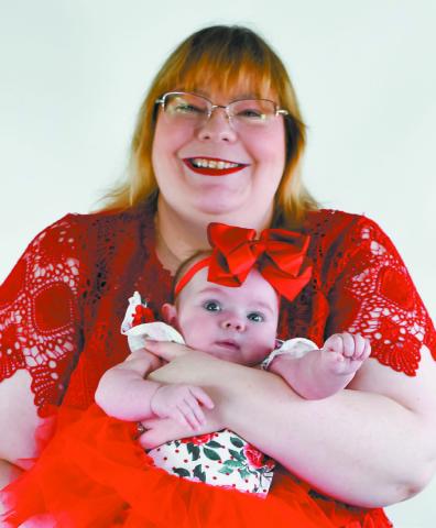 Alaina Clarke holding her daughter April during a family photo session. COURTESY OF CHELSIE CRAYCRAFT/ HUTCHESON PHOTOGRAPHY