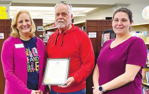 Mayor Ed Barbee presents proclamation to Branch Manager Julie King (l) and Lynn Applegate. DEBBIE LURIE-SMITH/Staff