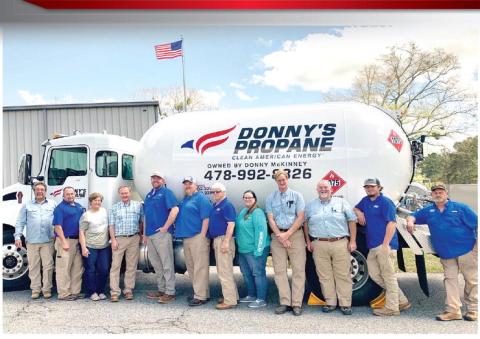 Donny’s Propane employees gather around one of the propane trucks for a photo at the company. ADAM SEGERS/Contributed