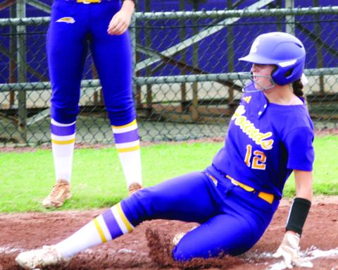 Genna Maki slides home as the Lady Greyhounds tack on runs against McDonough. BRAD HARRISON/Staff