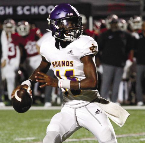 Greyhounds quarterback Devin Edmonds rolls out and looks downfield against Warner Robins. BRAD HARRISON/Staff
