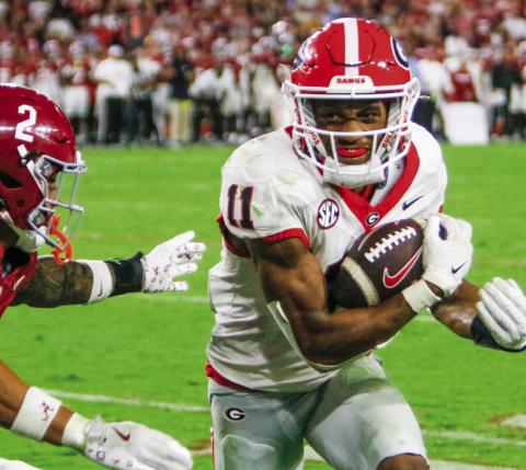 Georgia wide receiver Arian Smith (11) hauls in a 47-yard pass from quarterback Carson Beck during the fourth quarter of this past week’s game against Alabama. LANCE McCURLEY/Staff