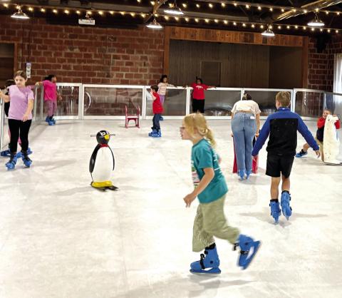 Youngsters enjoy ice skating inside Butler Hall, which is a new event this year as part of Main Street Gray’s Christmas Market. DEBBIE LURIE-SMITH/Staff