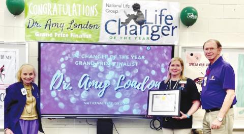 Margaret McCook (l-r), honoree Dr. Amy London and Allen McCook at the April 11 presentation. CONTRIBUTED