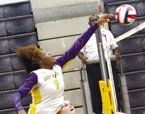 Nya Warren elevates to go up for a block during last Thursday’s split against Lamar