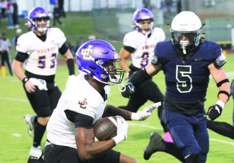 Zacarri Thomas drives the ball upfield for yardage in the first half on Friday. BRAD HARRISON/Staff