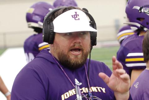 Former JCHS linebacker and now inside linebackers coach Chase Lundy shouts instructions during the Greyhounds’ spring scrimmage. BRAD HARRISON/Staff