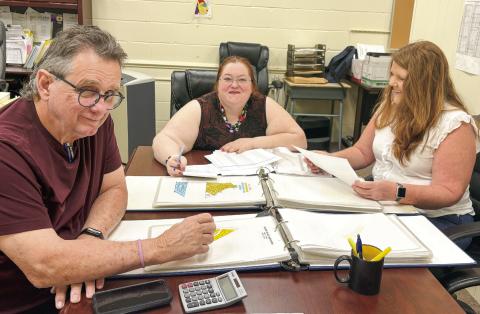 Jones County Appraisers Bill Goodman (l-r) and Kim Adams, who have led the huge effort of getting the county’s tax digest back in order, work with Mindy Pitrowski. DEBBIE LURIE-SMITH/Staff