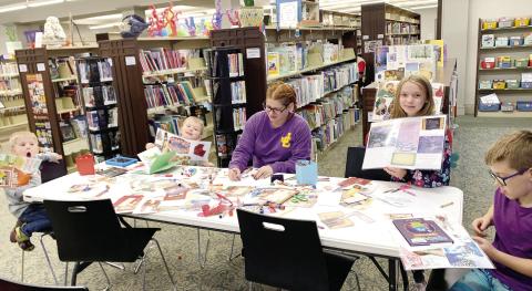 Families at the Jones County Public Library making Christmas placemats for their tables at home. CONTRIBUTED