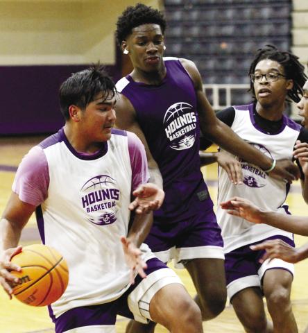 Tyler Wold, left, dribbles toward the basket during practice last week for the Greyhounds. BRAD HARRISON/Staff