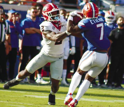 Georgia inside linebacker Smael Mondon (2) makes contact and tries to bring down Florida running back Trevor Etienne (7). LANCE McCURLEY/Staff