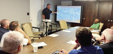 Gray Police Chief Adam Lowe uses a map of the city to point out problems caused by big trucks on former state routes. DEBBIE LURIE-SMITH/Staff