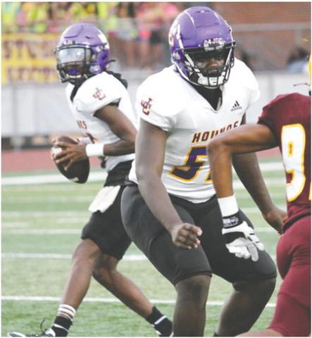 Greyhounds starting quarterback Devin Edmonds rolls out of the pocket to look downfield for a receiver in the first quarter against Perry. BRAD HARRISON/Staff