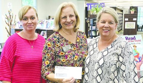 Barbara Merritt and Tracey Lowe from Exchange Bank donated $640 for the yearly movie license for the library. CONTRIBUTED