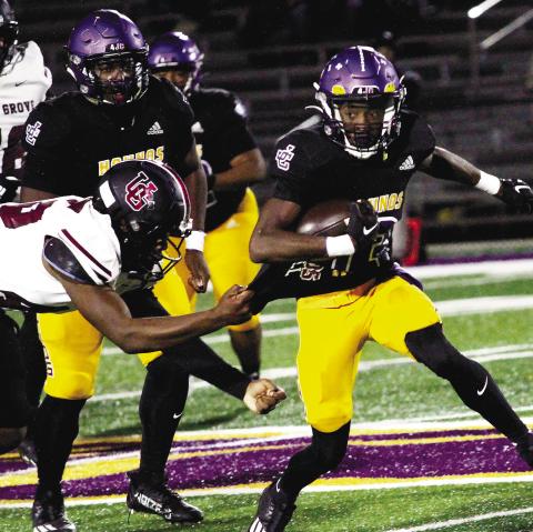 Zion Ragins escapes the grasp of the Wolverines to pick up extra yardage on Thursday. BRAD HARRISON/Staff