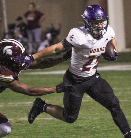Andrew Mullis shakes off a Trojans defender to bounce the ball outside during Friday’s second-round playoff game. BRAD HARRISON/Staff