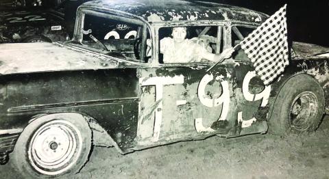 Shirley Beck with the flag after one of her many racing wins. CONTRIBUTED