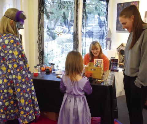 Participants dressed up at the Haunted Milledgeville reception and joined together in making potion souvenirs to take home. BAILEY BALLARD/Staff