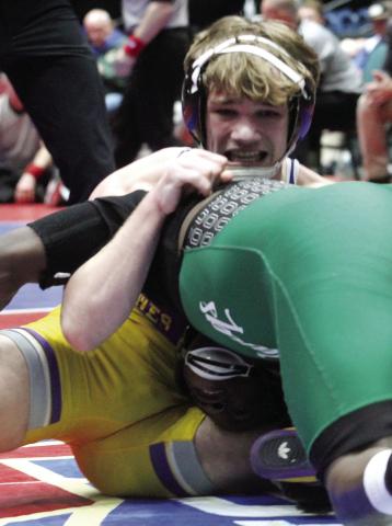 Arrie Martin works to pick up points during Friday night’s 4A 150-pound firstplace match. BRAD HARRISON/Staff