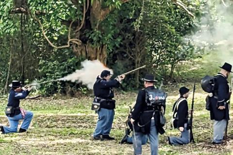 Union soldier re-enactors fire at Confederate soldier re-enactors at Old Clinton War Days in Jones County. NATHAN CLARKE/Contributed