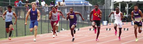 Zion Ragins, center lane, speeds to the front of the pack during Saturday’s 100-meter event at the GHSA State Track Championships. BRAD HARRISON/Staff