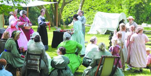 Ladies in period clothing at Old Clinton War Days gathering in fellowship at the camps. FILE PHOTO