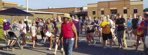 Prayer Walk participants circle the Jones County High School building July 24 while praying for the new school year. BRANDY ROUND/Contributed