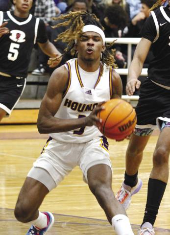 Jaylen Sanford splits through two Demon defends during Friday’s game against Warner Robins. BRAD HARRISON/Staff