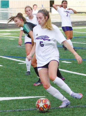 Emily Brennaman blasts the ball upfield against McIntosh. BRAD HARRISON/Staff