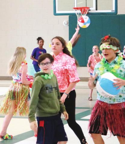 The fifth graders at Turner Woods Elementary School running around and playing during the luau. NATHAN CLARKE/Contributed