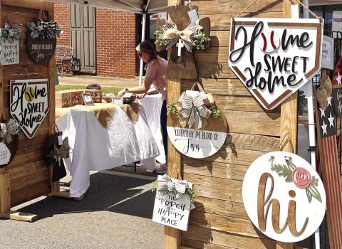 A vendor at the Hometown Spring Festival last year selling signs in downtown Gray. FILE PHOTO