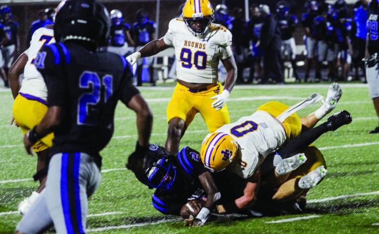 Hunter Hardwick (0) careens Burke County’s Ranquavious Morris to the ground during Friday’s shutout win. BRAD HARRISON/Staff