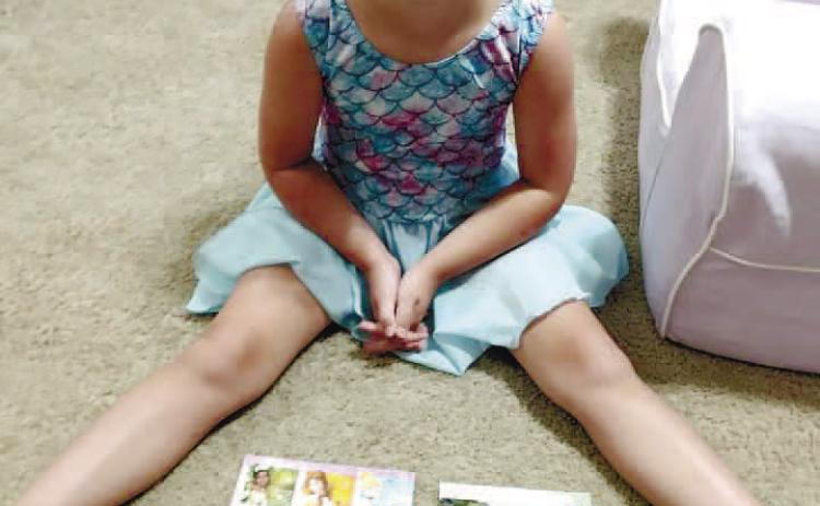 Fischer with a few of the colorful postcards she has received in the mail from people across the states.