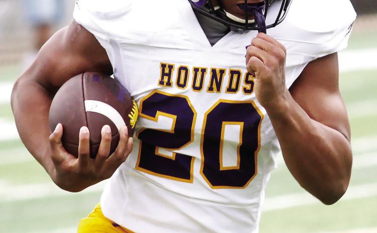 Laquan Pendleton finds a crease to pick up yardage during last week’s scrimmage. BRAD HARRISON/Staff