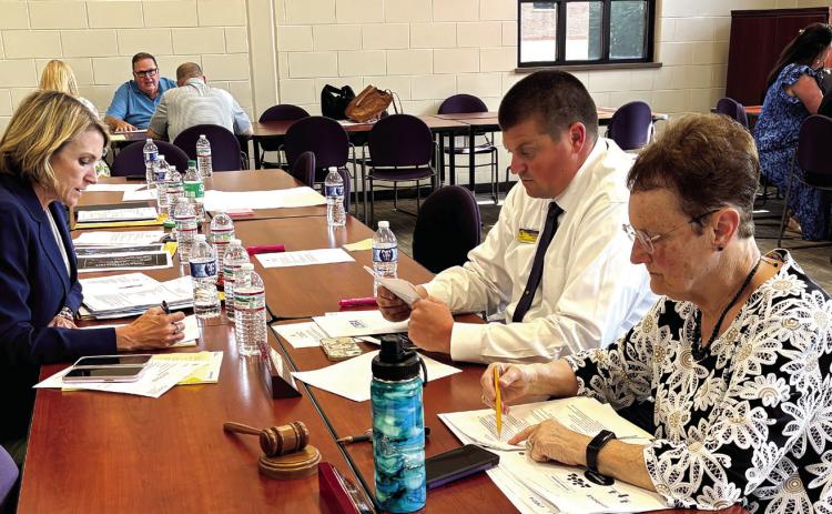 Jones County Superintendent Dr. Jessica Graves (l-r), JCHS Principal Chance Scott and Board Chairman Ginger Bailey work on norms and protocols. DEBBIE LURIE-SMITH/Staff