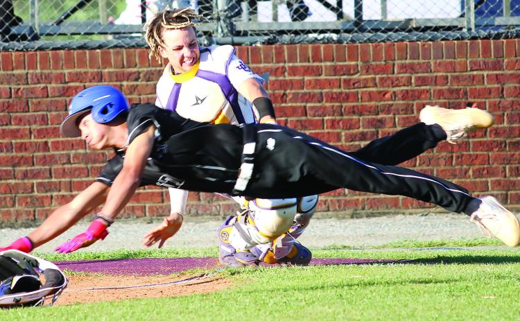 Greyhounds catcher MJ Lane applies the tag for the out at home after getting the throw from left field by Cohen Barfield. BRAD HARRISON/Staff