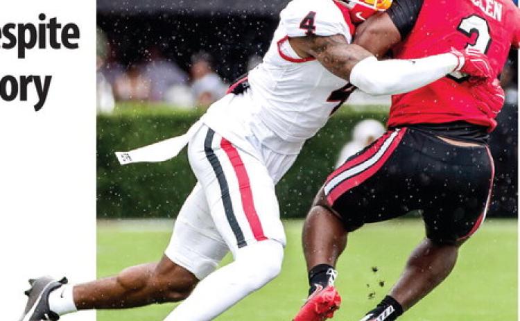 Georgia defensive back KJ Bolden takes down Western Kentucky’s Ajay Allen on the way to the Bulldogs’ 70-20 win. SKYLA MORRIS/Staff
