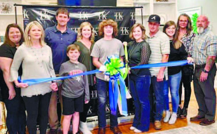 Tory Etheridge with TK Med Spa and the Chamber of Commerce holding the business’s ribbon cutting ceremony. CONTRIBUTED
